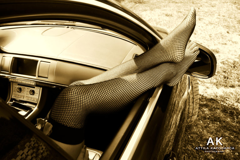 Budapest boudoir and erotic photographer legs in stockings out of a car window