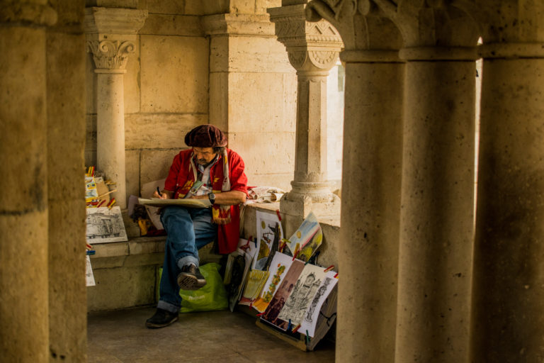 Budapest photographer for tourists captures a painter at Fisherman's bastion