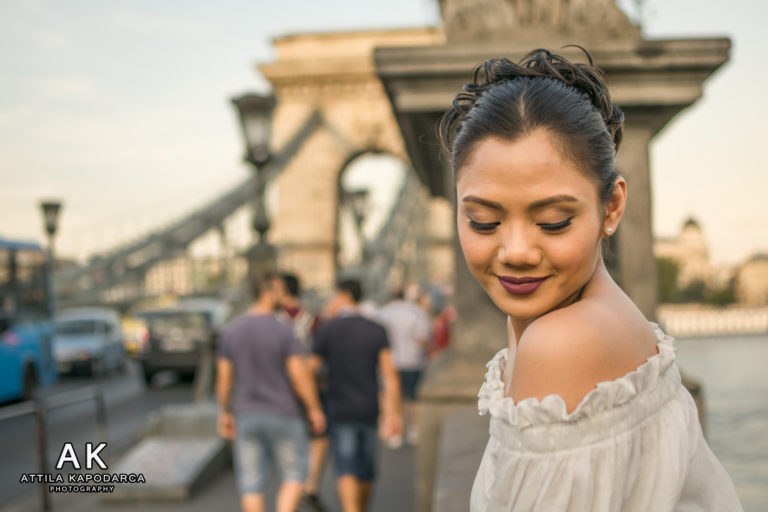 Budapest photographer for tourists captures asian tourist on chain bridge