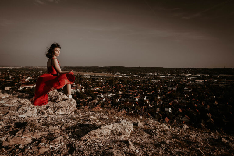 Budapest photographer for tourists captures red dress portrait in Budaors