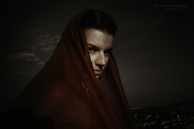 Budapest photographer for tourists captures woman and red veil from Budaors by Attila Kapodarca
