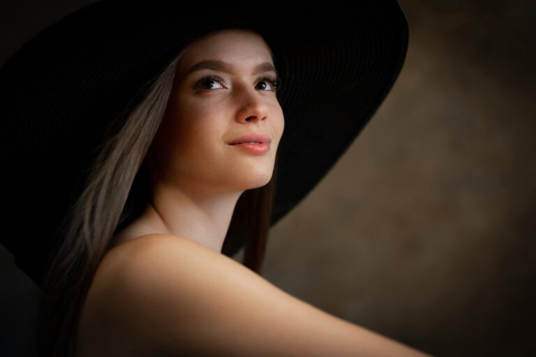 A young woman poses in studio for Attila Kapodarca