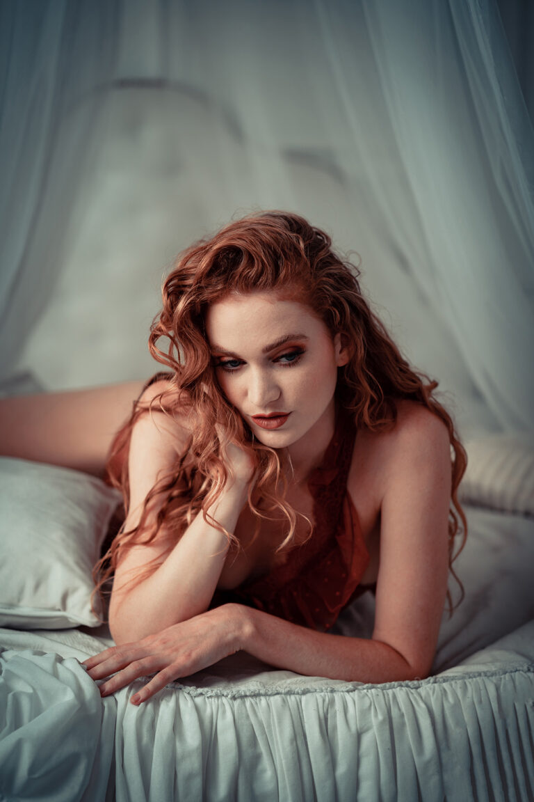 A beautiful woman in waiting on a bed