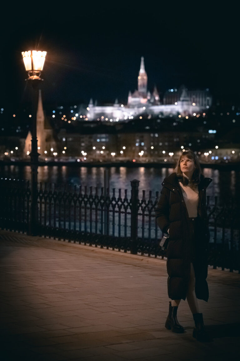 Woman walking in Budapest at night